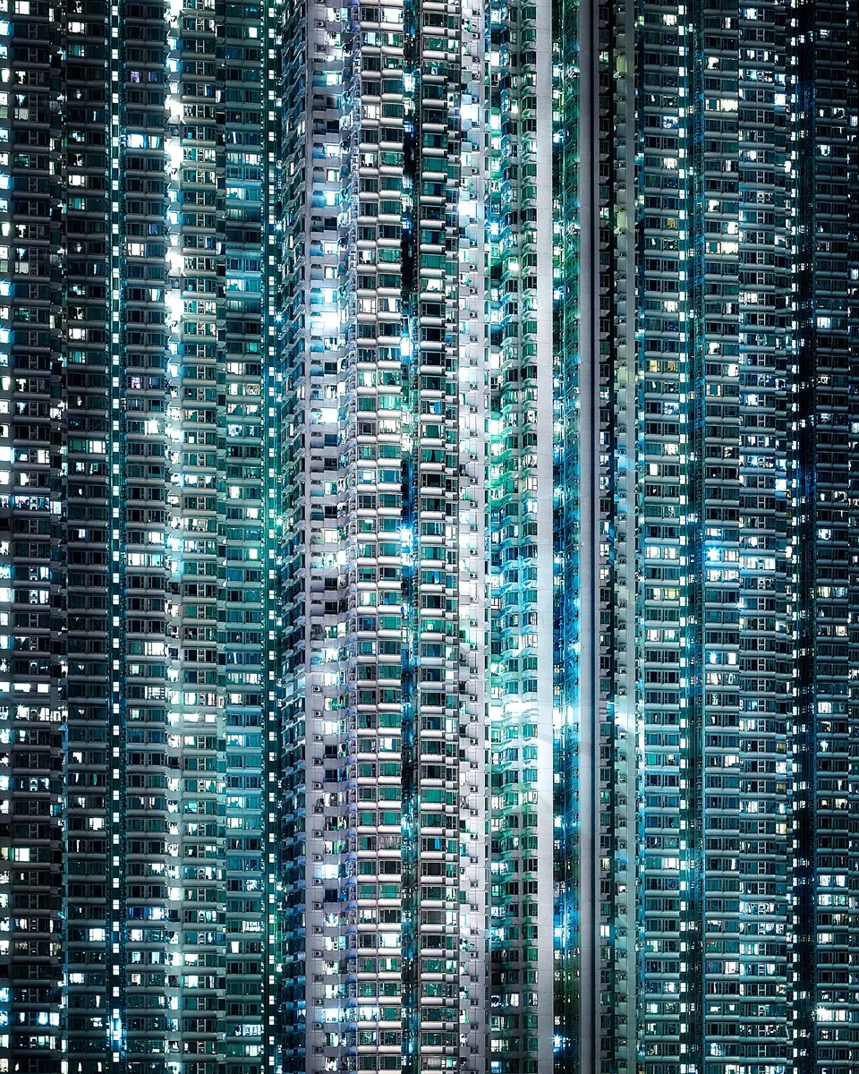 Memory Fragments, the facade of a dense Hong Kong apartment tower at night, hundreds of lit windows